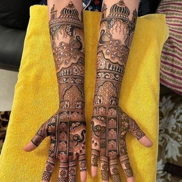 Intricate bridal mehndi design with peacock and floral patterns on hands